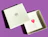 An open white gift box branded 'MAUVERIEN' revealing a printed heart illustration and message inside, set against a purple background