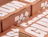 Close-up of stacked kraft mailer boxes with large white lettering and graphic shapes