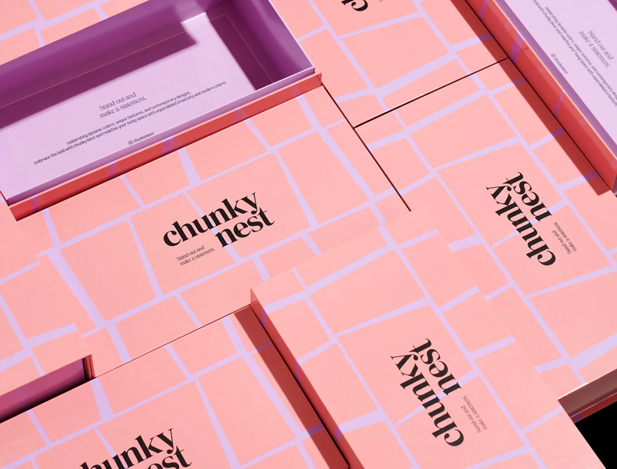 Multiple pink gift boxes with a light purple grid pattern and 'chunky nest' logo spread out on a surface